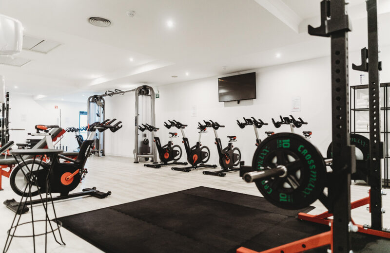 Fitness studio with cardio bikes and free weights